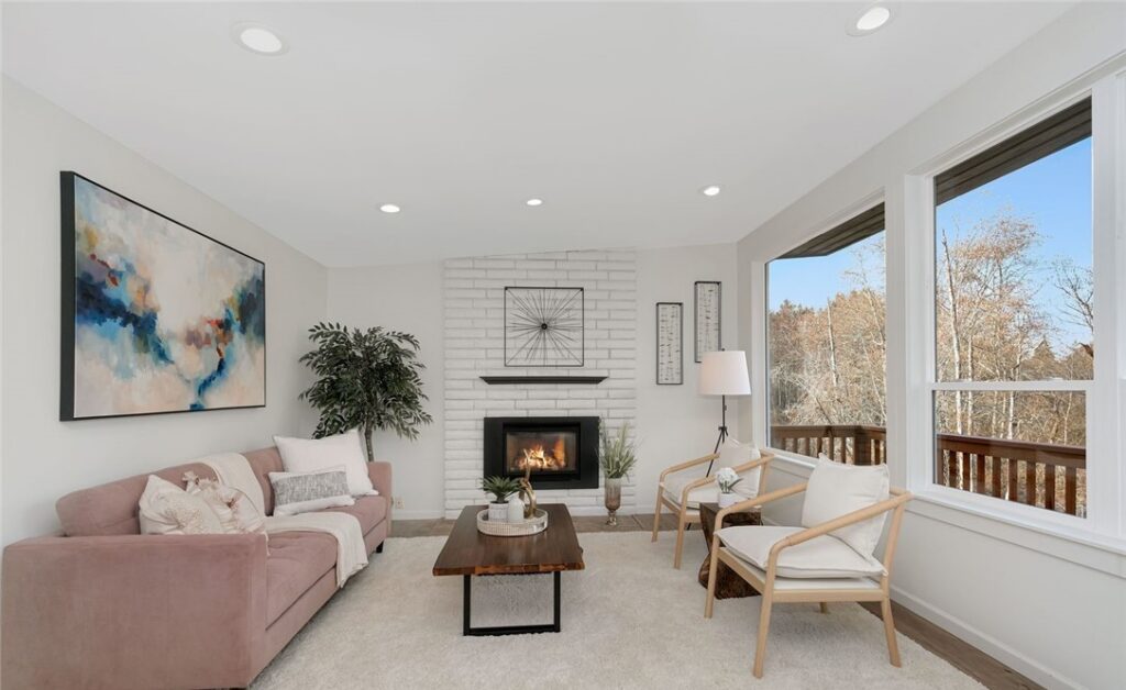 Bellevue home staging in a mid-century modern living room with a fireplace, large-scale art and wide windows