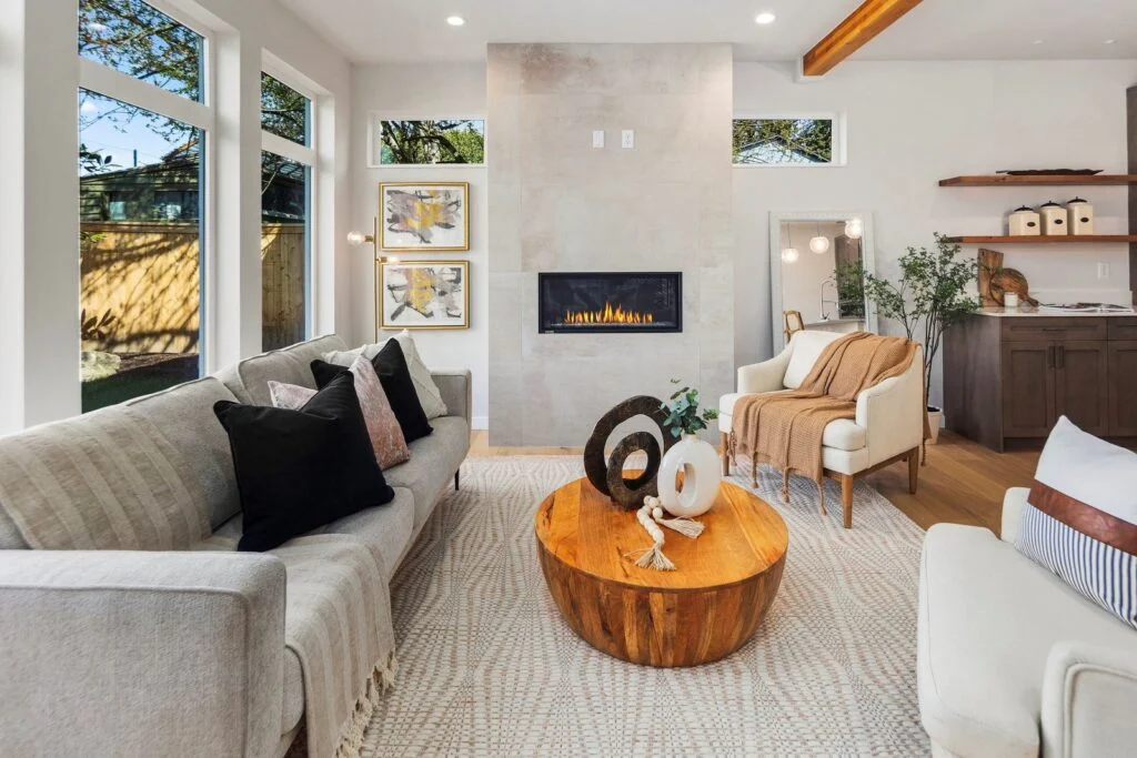 Staged living room with fireplace in a new construction Kirkland home by IntExt Staging