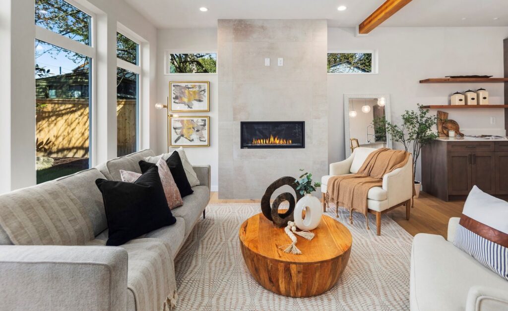 Kirkland home staging in a new construction living room with a linear fireplace, sofa and lounge chairs
