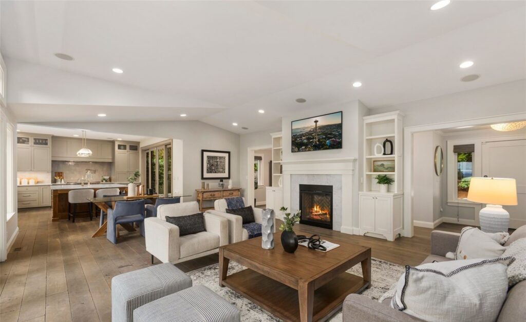 Living room arranged around a fireplace with warm lamps and layered seating