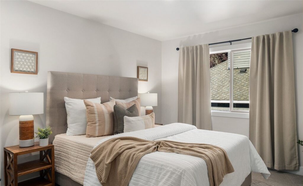 Newcastle bedroom with bed, layered bedding and artwork, designed by IntExt