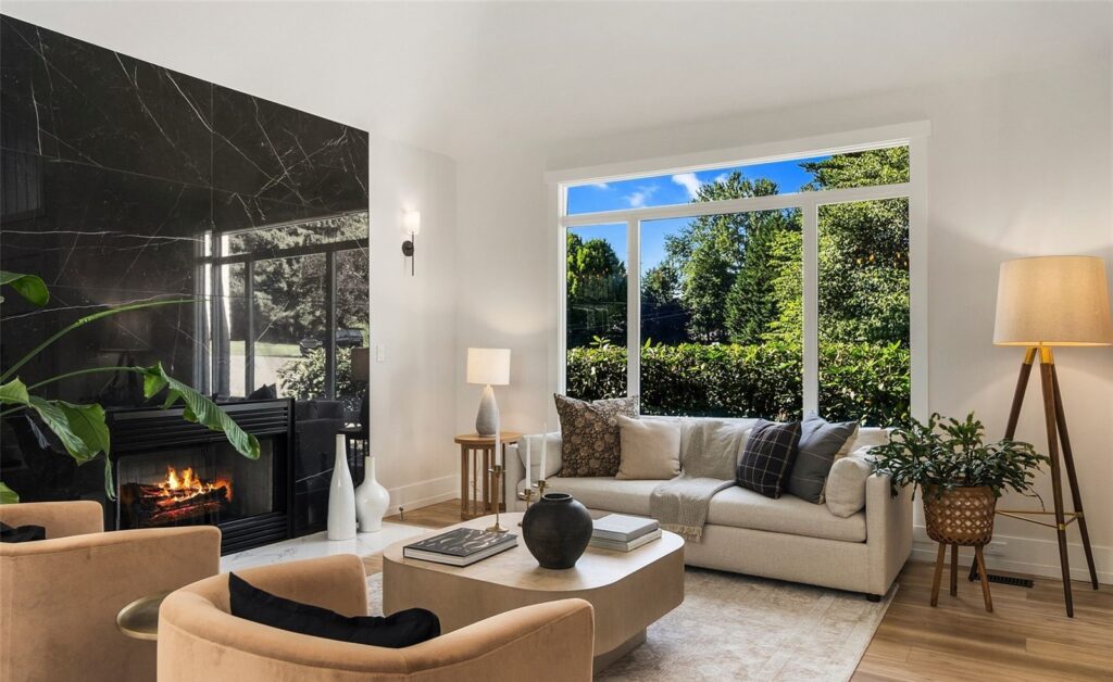 Staged living room with sofa, accent chair and garden view in a Newcastle home, by IntExt Staging
