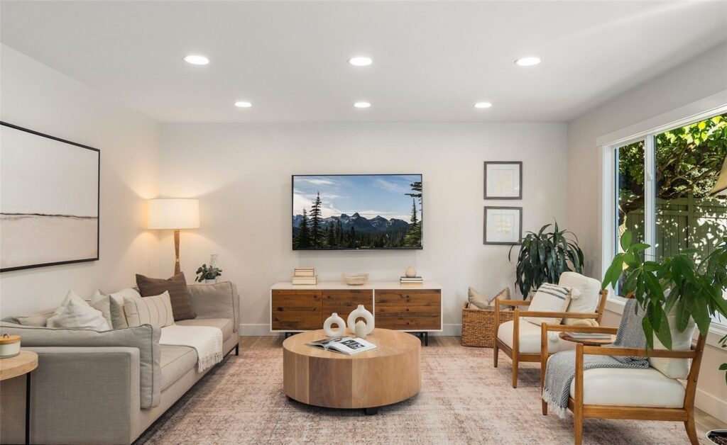 Staged living room with sofa, rug and accent chairs in a Newcastle home, by IntExt Staging