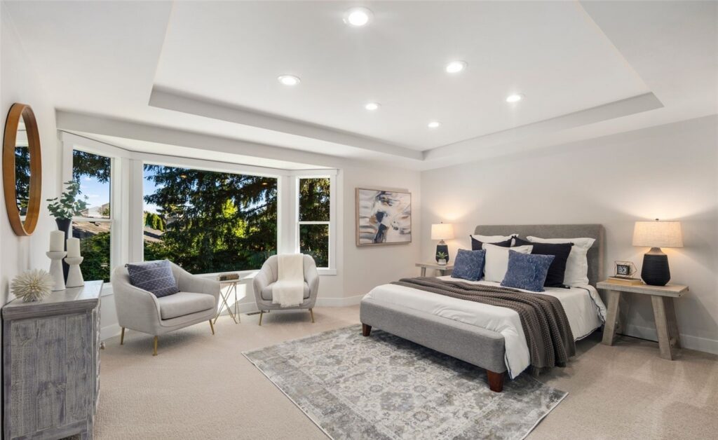 Staged primary bedroom with real bed, headboard and layered bedding in a Newcastle home, by IntExt Staging