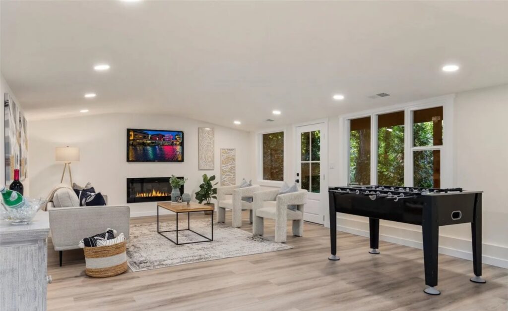 Downstairs game room with foosball table and lounge seating in Normandy Park, designed by IntExt