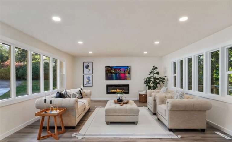 Staged living room with tufted sofas, ottoman and fireplace in a Normandy Park home, by IntExt Staging