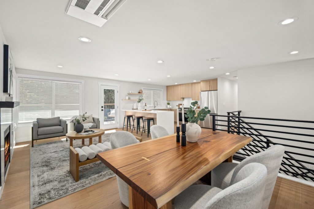 Live-edge dining table with upholstered chairs, opening to the staged living room
