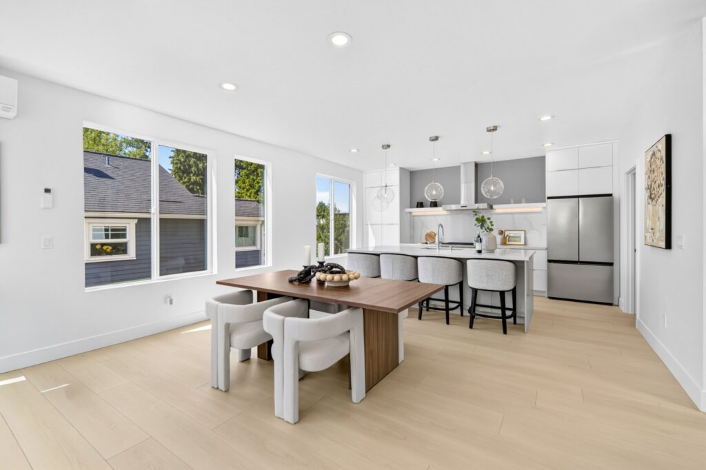 Dining table with upholstered chairs beside the kitchen in a Seattle townhouse