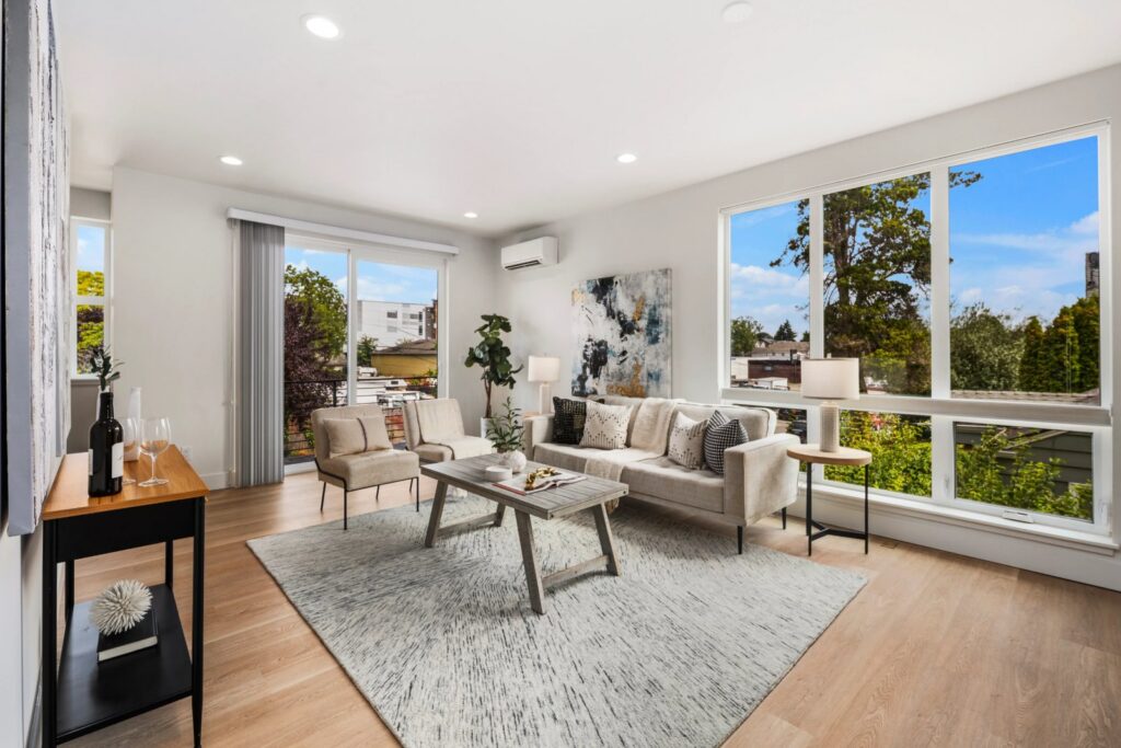 Staged living room with a rug, sofa and wall of windows in a Seattle home, showing how to stage a condo-style space