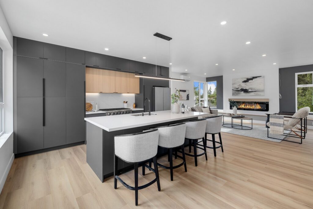 Kitchen island with four counter stools, open to the living room in a Seattle townhouse