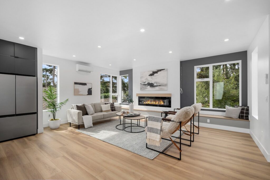Vacant home staging in a Seattle townhouse living room with a fireplace, sofa and lounge chairs