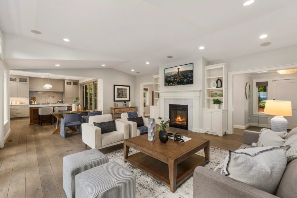 Staged living room with a fireplace and layered seating in a Seattle home, the result of the home staging process by IntExt Staging